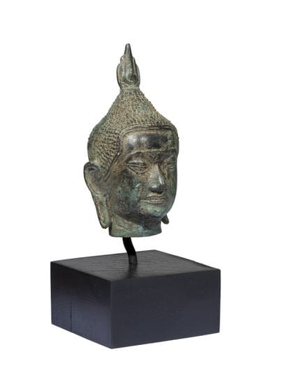 Buddha head in bronze with green patina.
Southeast...