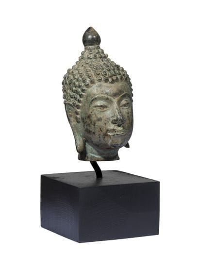Buddha head in bronze with green patina....