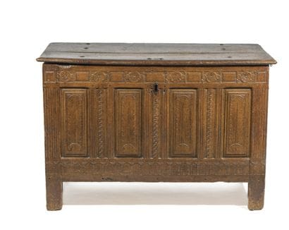 Rectangular oak chest with carved panels.
It...