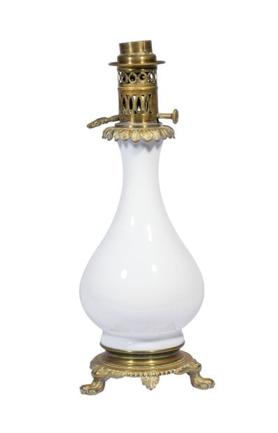 A kerosene lamp consisting of a white opaline...