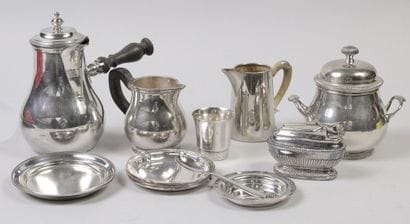 A set of silver plated metal pieces consisting...