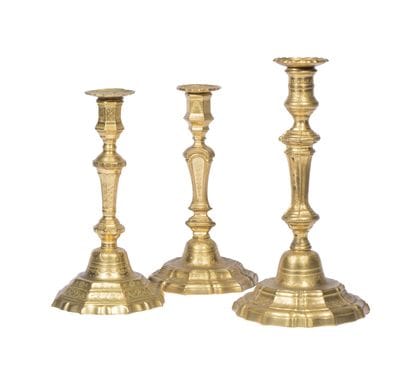 Set of three gilded bronze candlesticks decorated...