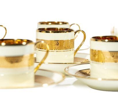 Ten porcelain cups and twelve saucers decorated...