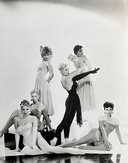 KIM NOVAK
Entourée de figurantes-mannequins,...