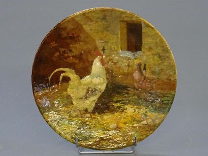 Plat en céramique à décor emaillé d'un coq...