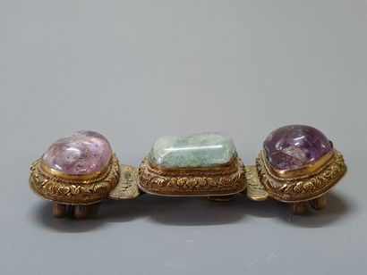 Bronze belt buckle and three hard stone cabochons....