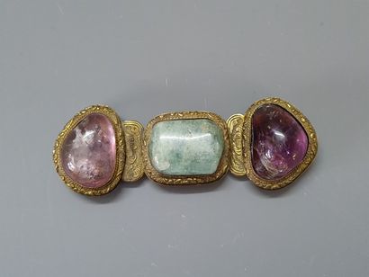 Bronze belt buckle and three hard stone cabochons....