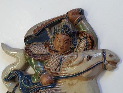 Glazed ceramic bas relief depicting an Asian...