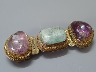 Bronze belt buckle and three hard stone cabochons....