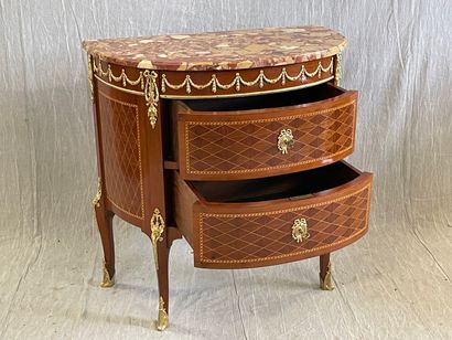 Commode demi-lune en marqueterie et bronzes.

Style...