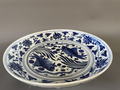 Plat rond en faience à décor de poissons....