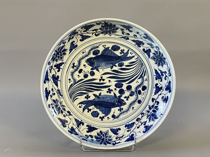 Plat rond en faience à décor de poissons....