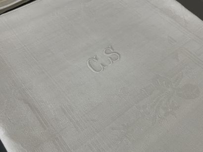 Damask tablecloth framed with bouquets of...