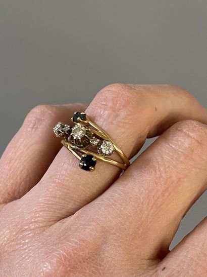 Gold ring set with five diamonds, highlighted...