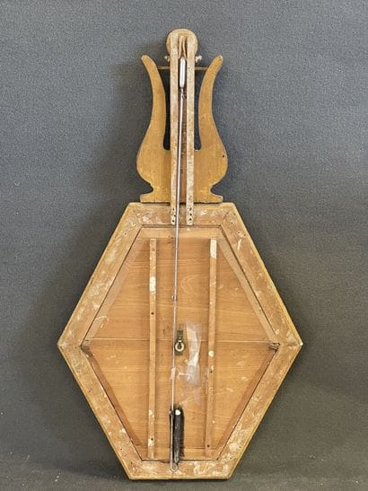 Baromètre en bois doré surmonté d'une lyre.

Epoque...
