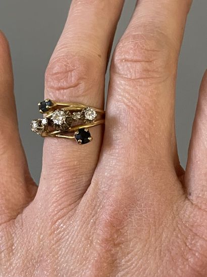 Gold ring set with five diamonds, highlighted...
