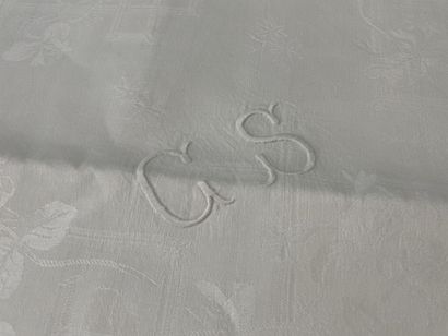 Damask tablecloth framed with bouquets of...