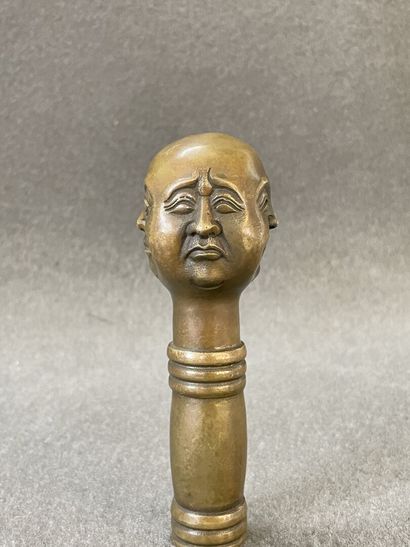 Asian cane knob in bronze representing the...