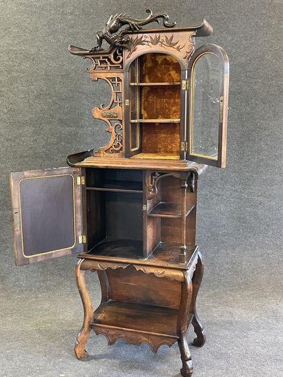 Mahogany japanese showcase, topped by a carved...