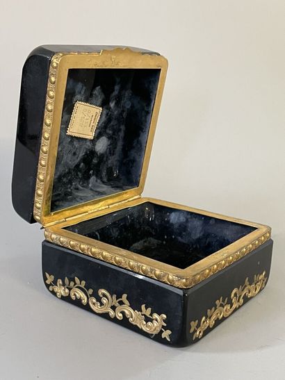 Black glass case with floral decoration,...