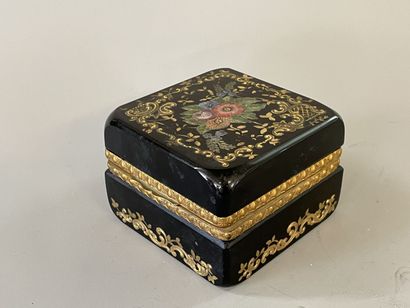 Black glass case with floral decoration,...