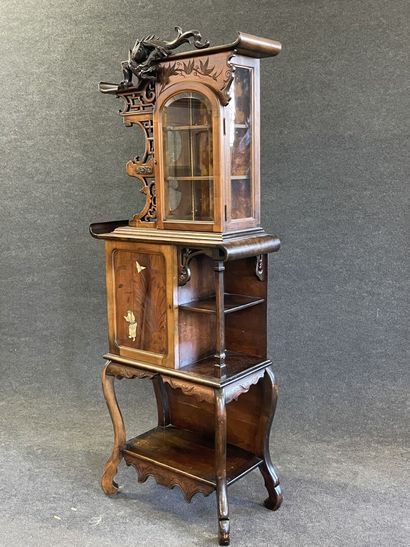 Mahogany japanese showcase, topped by a carved...