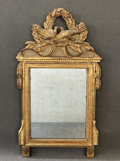 Wood and gilded stucco pediment mirror decorated...
