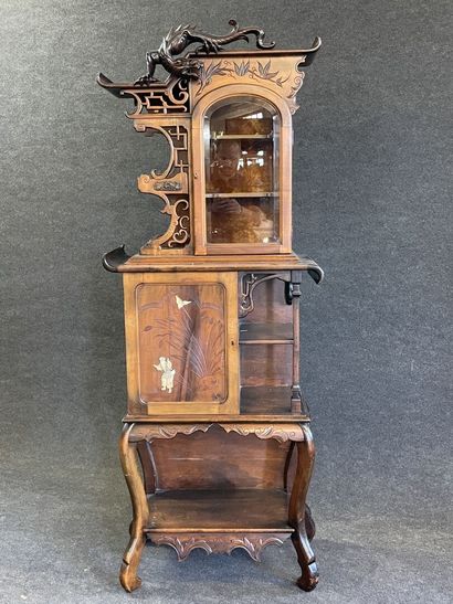 Mahogany japanese showcase, topped by a carved...