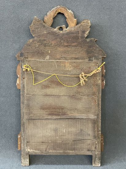 Wood and gilded stucco pediment mirror decorated...
