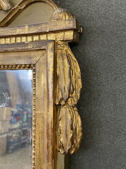 Wood and gilded stucco pediment mirror decorated...