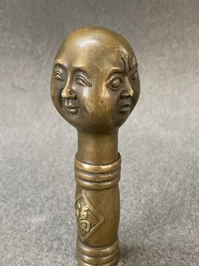 Asian cane knob in bronze representing the...