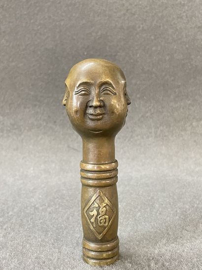 Asian cane knob in bronze representing the...