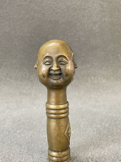 Asian cane knob in bronze representing the...