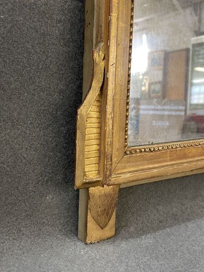 Wood and gilded stucco pediment mirror decorated...