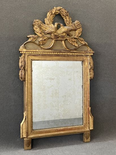 Wood and gilded stucco pediment mirror decorated...