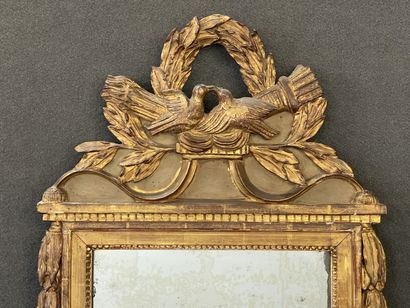 Wood and gilded stucco pediment mirror decorated...