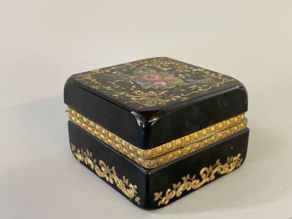 Black glass case with floral decoration,...