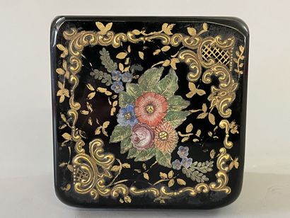 Black glass case with floral decoration,...