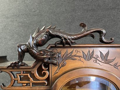 Mahogany japanese showcase, topped by a carved...