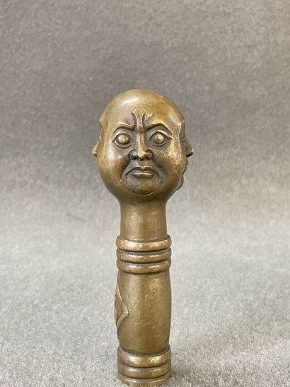 Asian cane knob in bronze representing the...