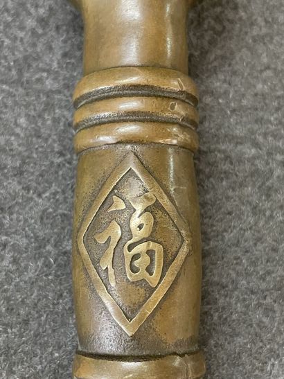Asian cane knob in bronze representing the...