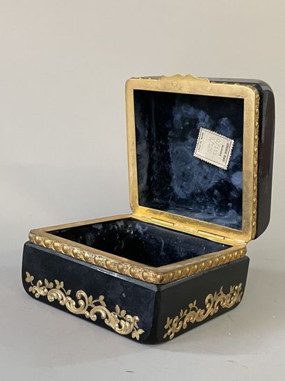 Black glass case with floral decoration,...