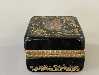 Black glass case with floral decoration,...