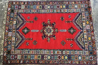 Large Moroccan carpet red background.

287...