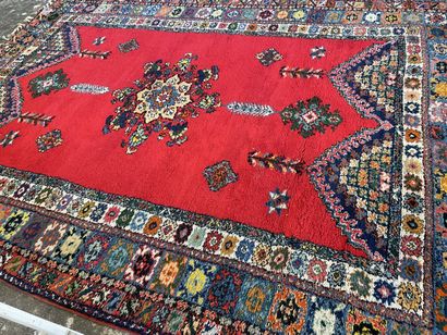 Large Moroccan carpet red background.

287...