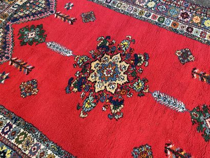 Large Moroccan carpet red background.

287...