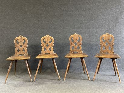 Suite of four Alsatian chairs in carved wood.

Beginning...