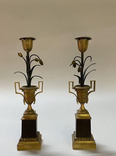 Pair of candlesticks in gilded and patinated...