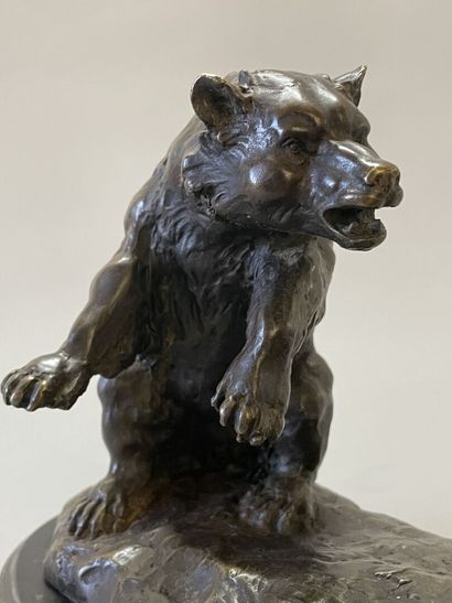 Bison facing a bear. 
Modern sculpture in...