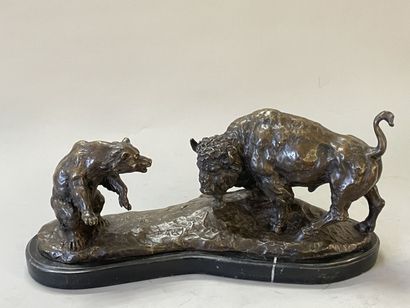 Bison facing a bear. 
Modern sculpture in...